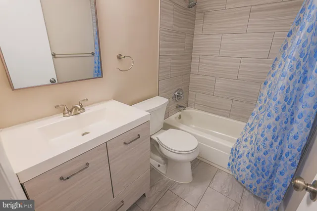 a bathroom with a toilet sink and a mirror