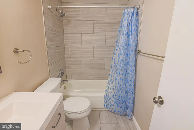 a bathroom with a toilet and shower