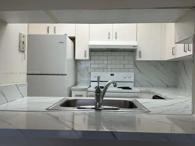 a view of a bathroom with a glass door shower and a sink
