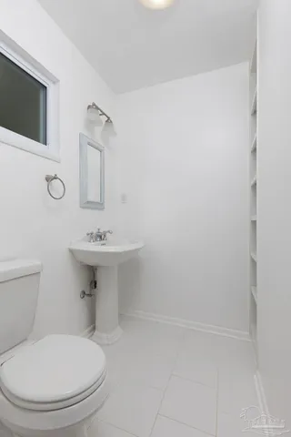 a kitchen with granite countertop sink stove and white cabinets