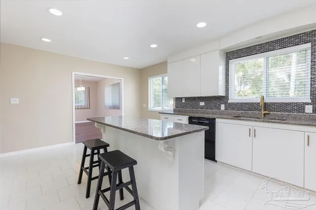an empty room with wooden floor windows and entrance