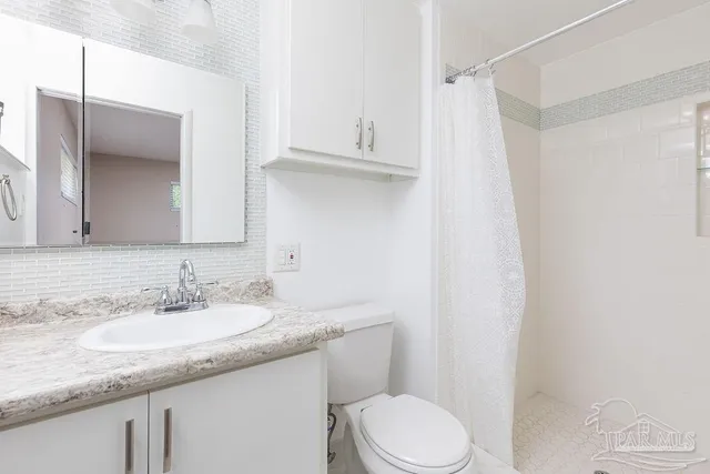 a bathroom with a shower and toilet
