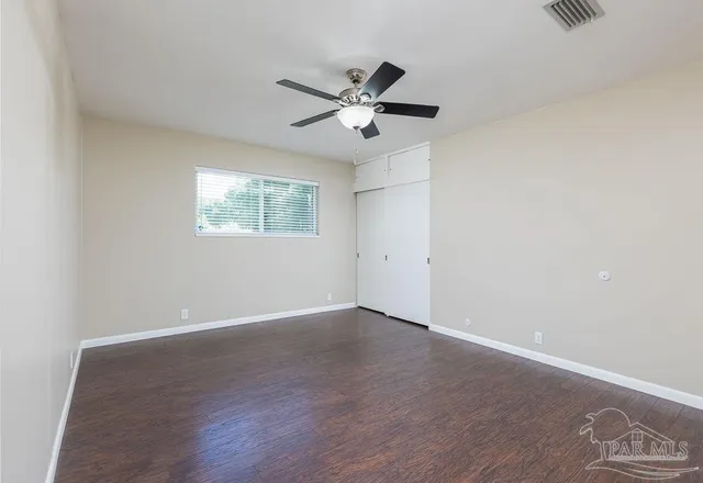 an empty room with wooden floor