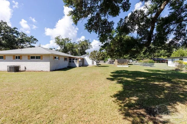 a view of a park with large trees