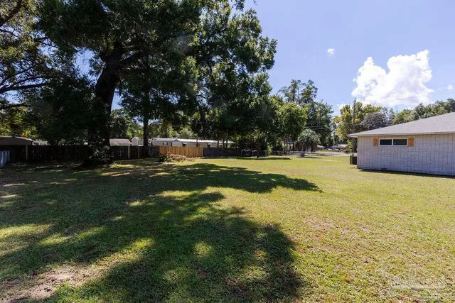 a view of a house with a yard and garage