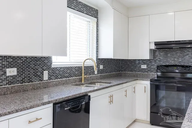 a kitchen with stainless steel appliances granite countertop a stove and a refrigerator