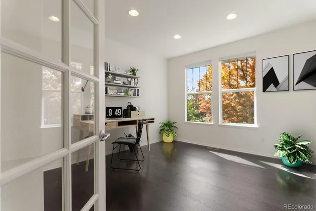 a view of a workspace with furniture and a window