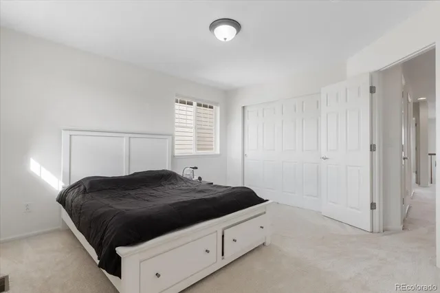 a bedroom with a bed and a night stand