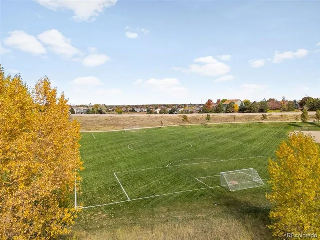 an aerial view of a house with a yard and lake view