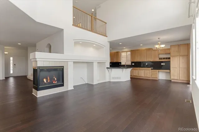 a view of a kitchen with a stove wooden floor and a fireplace