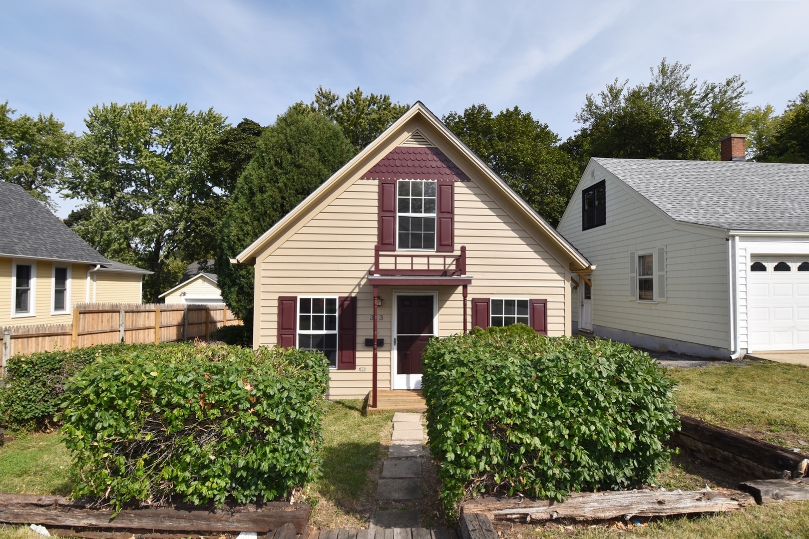 313 East State Street Geneva, IL 60134 - Photo 1 of 31 a view of a house with a yard and potted plants