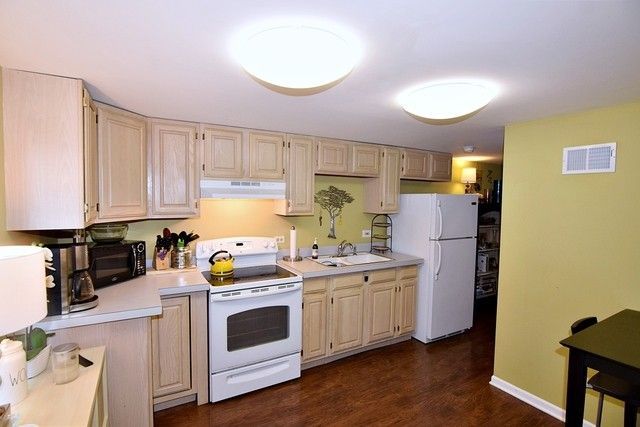 313 East State Street Geneva, IL 60134 - Photo 9 of 31 a kitchen with white cabinets and white appliances