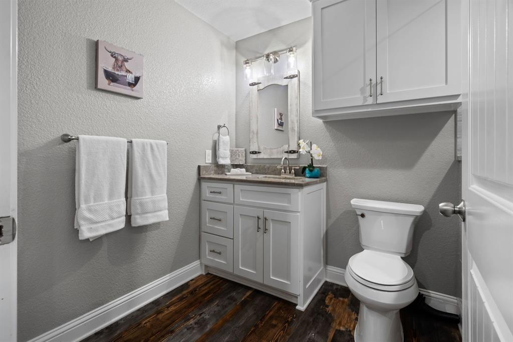 175 Porter Road Bartonville, TX 76226 - Photo 34 of 40 a bathroom with a toilet sink and mirror