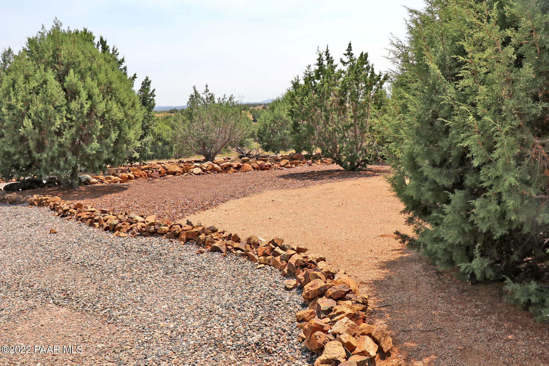 17001 Crossroads Ranch Road Prescott, AZ 86305 - Photo 44 of 54 a view of a dirt road with trees in the background