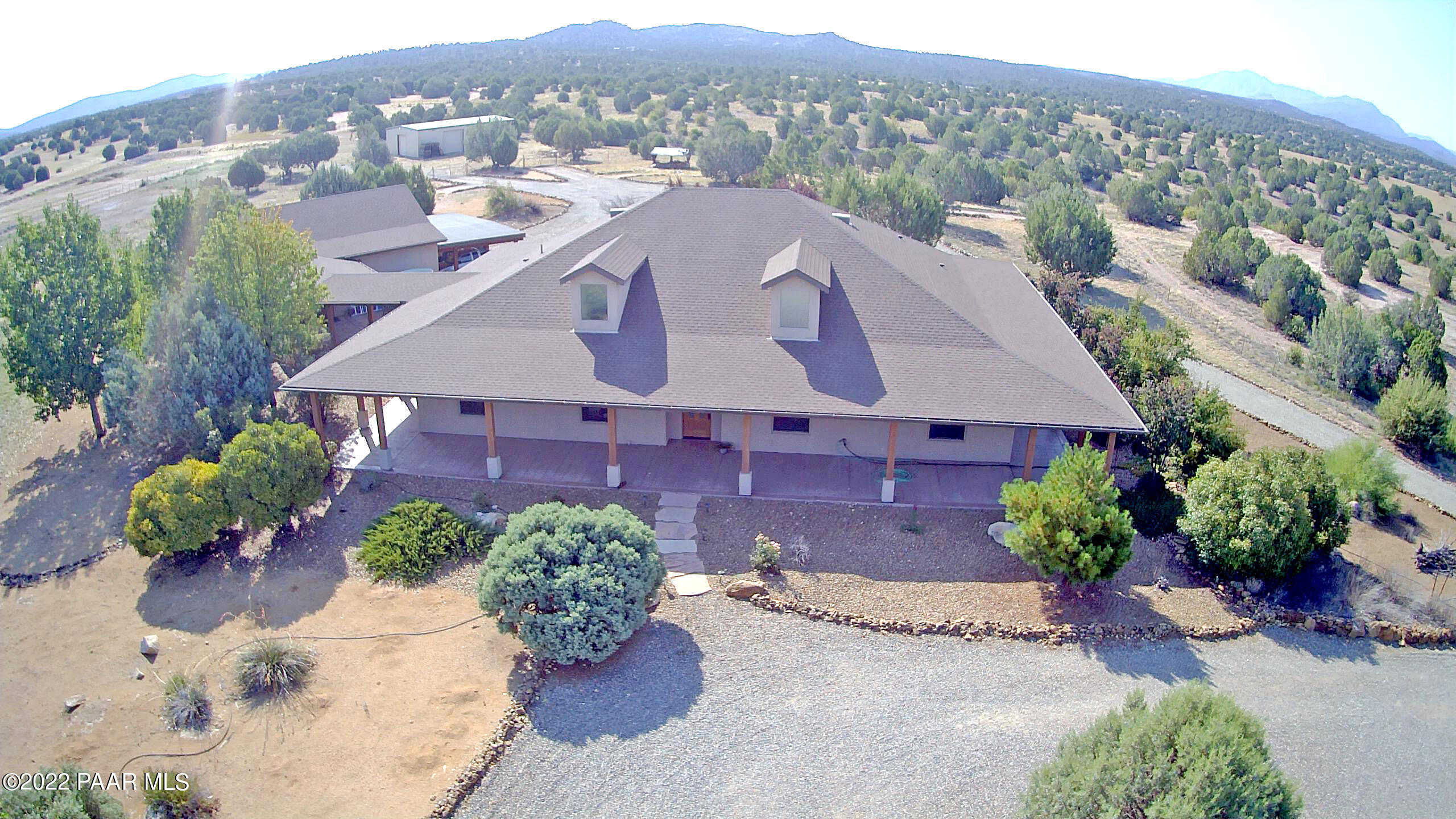 17001 Crossroads Ranch Road Prescott, AZ 86305 - Photo 7 of 54 an aerial view of a house with a yard and a lot of flower plants