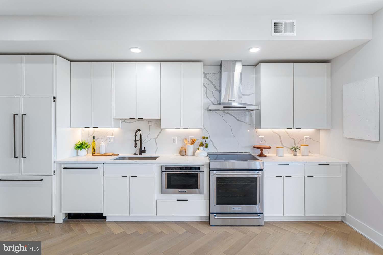1516 East Capitol Street Northeast, Unit F Washington, DC 20003 - Photo 14 of 53 a kitchen with stainless steel appliances a stove a sink and a refrigerator