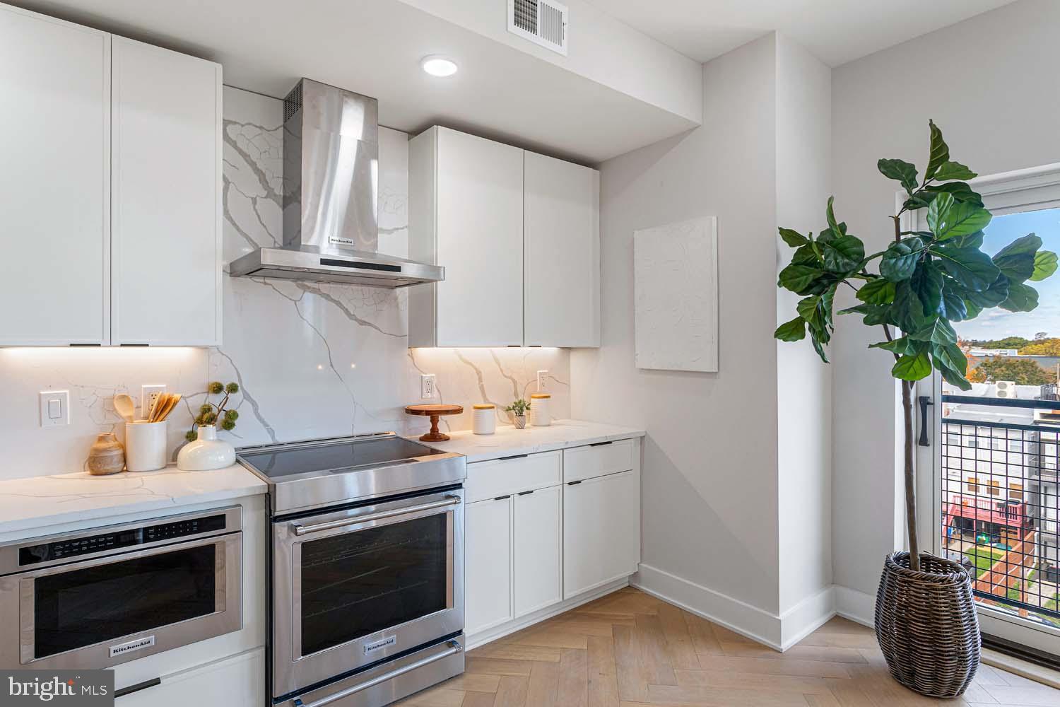 1516 East Capitol Street Northeast, Unit F Washington, DC 20003 - Photo 15 of 53 a kitchen with a white stove and white cabinets