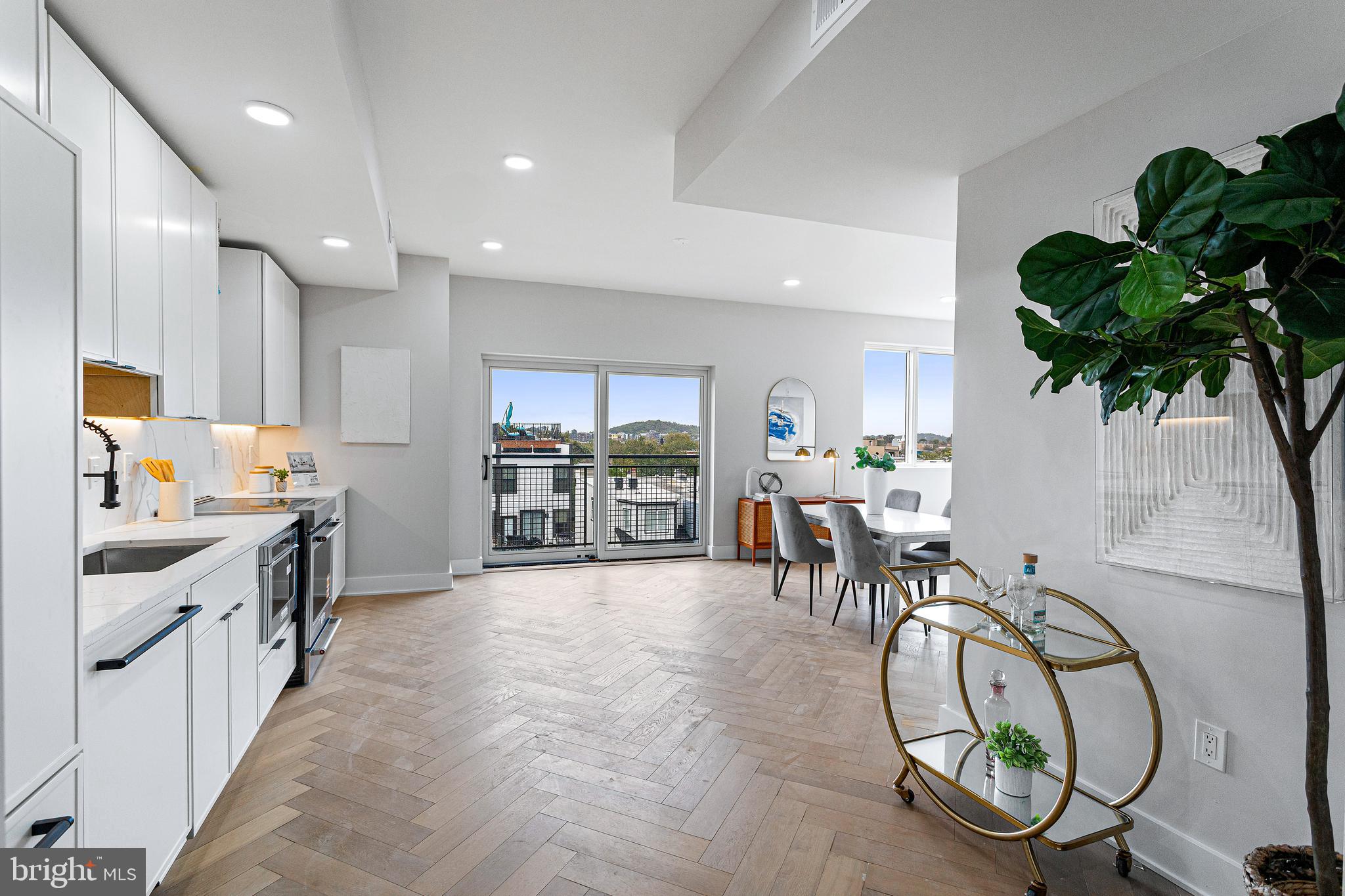 1516 East Capitol Street Northeast, Unit F Washington, DC 20003 - Photo 21 of 53 a very nice looking open dining room with kitchen island furniture a chandelier a large window and a view of living room