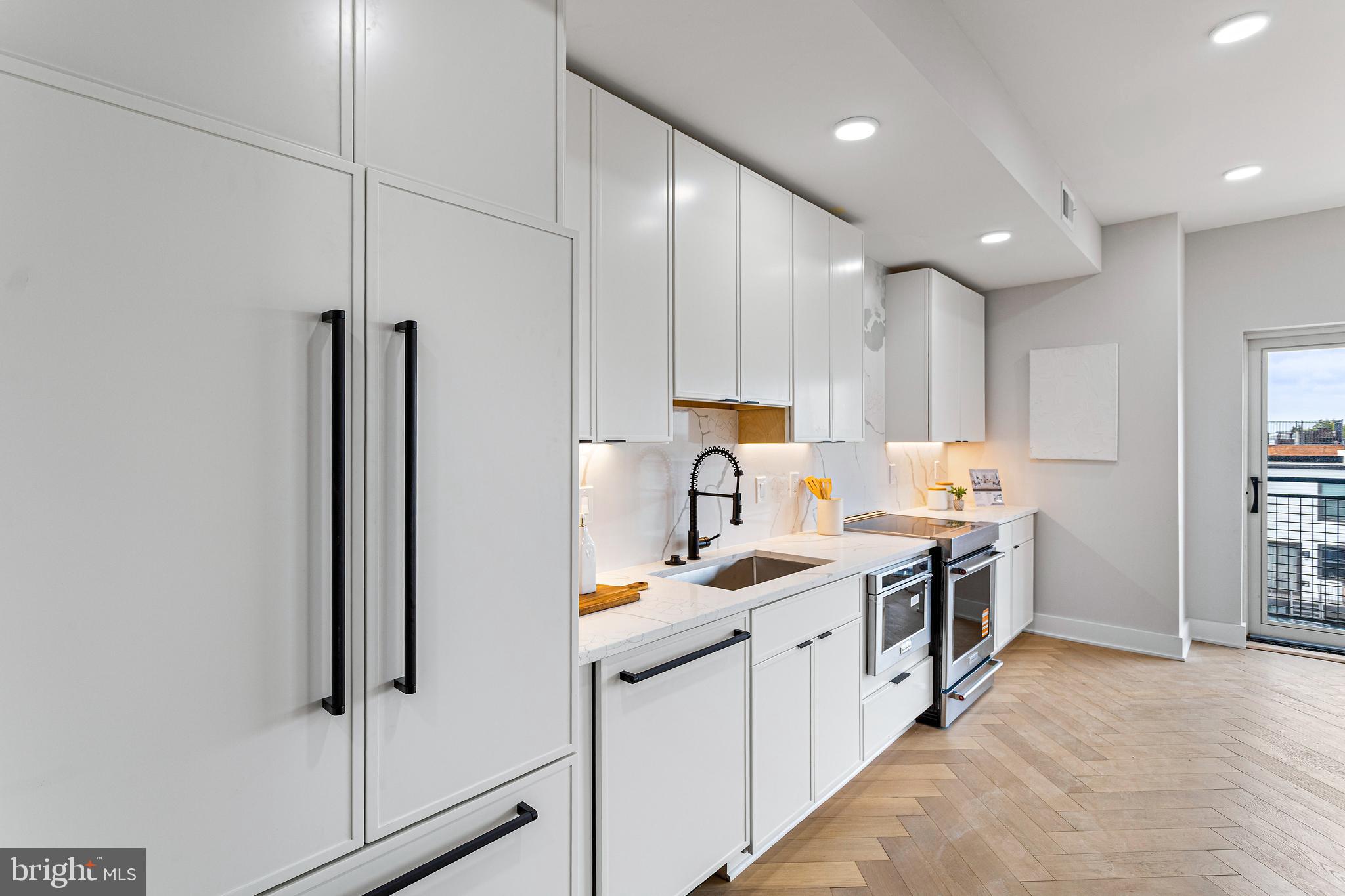 1516 East Capitol Street Northeast, Unit F Washington, DC 20003 - Photo 22 of 53 a kitchen with stainless steel appliances granite countertop a sink stove and refrigerator