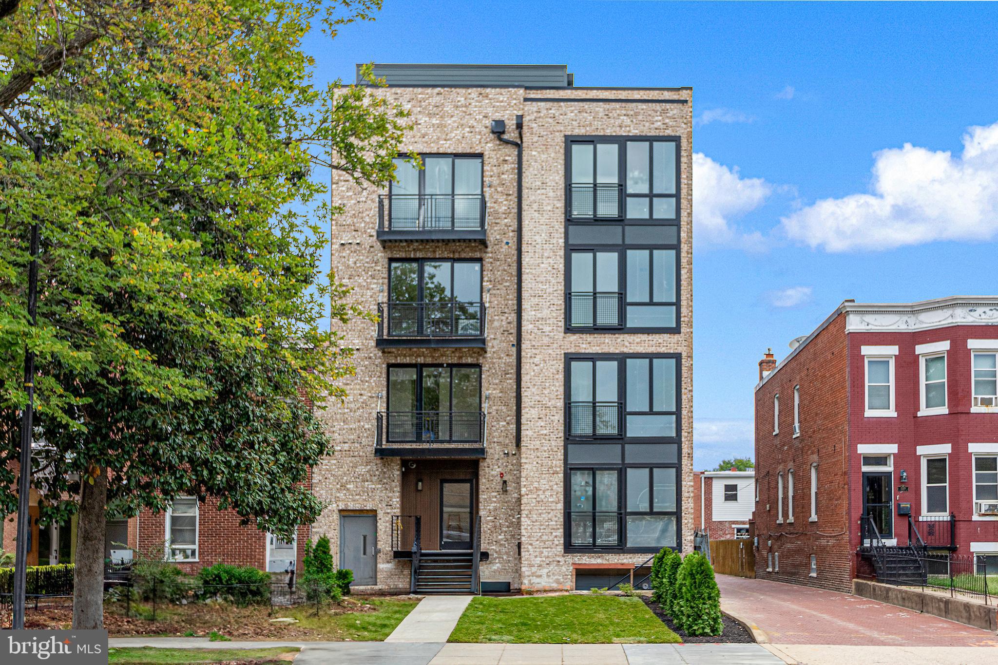 1516 East Capitol Street Northeast, Unit F Washington, DC 20003 - Photo 41 of 53 a front view of a residential apartment building with a yard