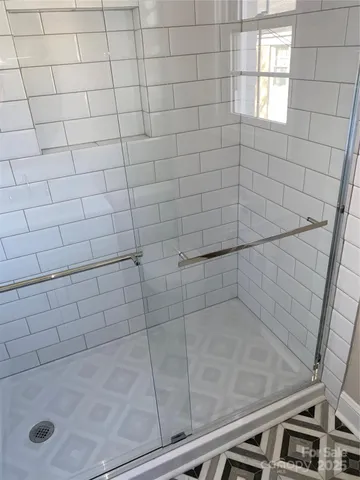 a view of an empty room with wooden floor and closet