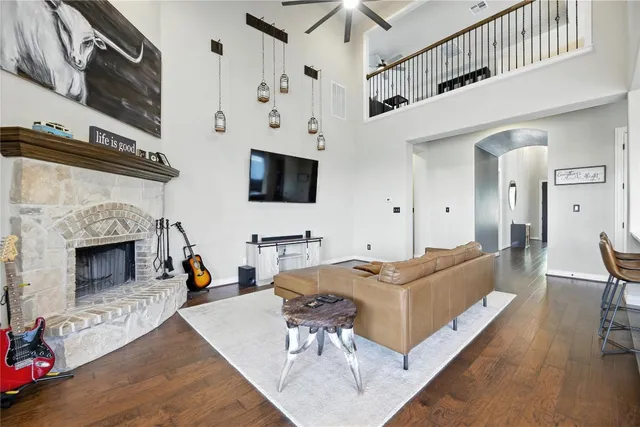 a living room with furniture a flat screen tv and a fireplace