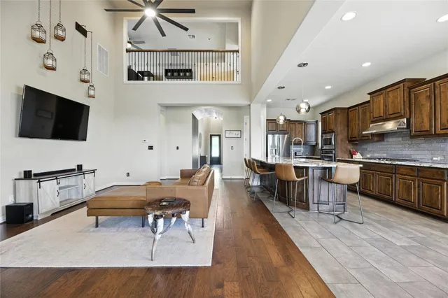 a living room with stainless steel appliances kitchen island granite countertop furniture and a kitchen view