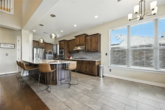 a kitchen with a sink a counter top space and appliances