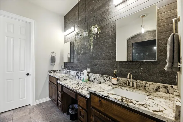 a bathroom with a sink double vanity and a mirror