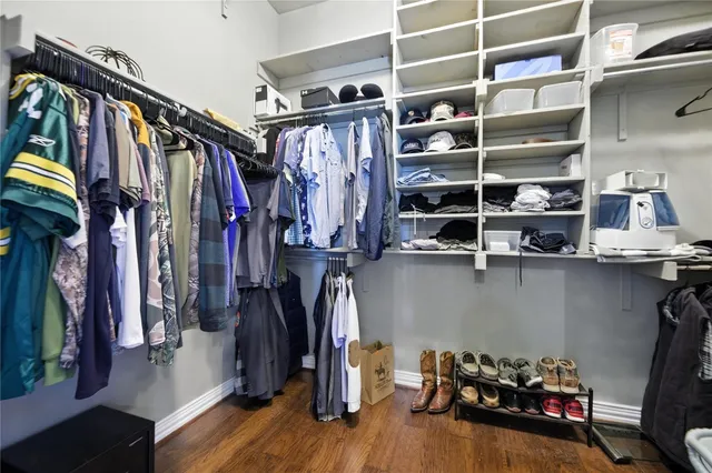 a view of walk in closet with clothes and shoes
