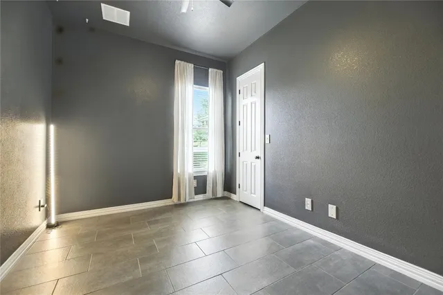 an empty room with windows and closet