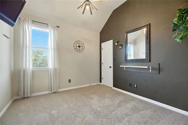 an empty room with windows and closet