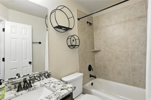 a bathroom with a sink a toilet and a bathtub