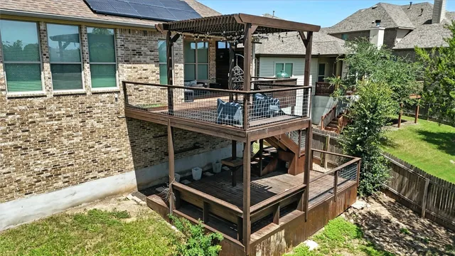 a view of house with roof deck and furniture