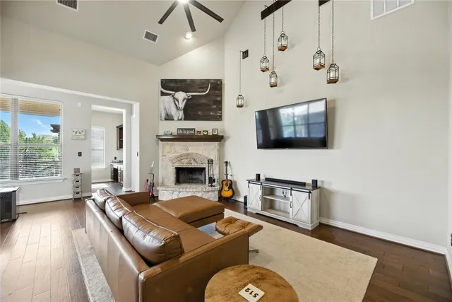 a living room with furniture fireplace and flat screen tv