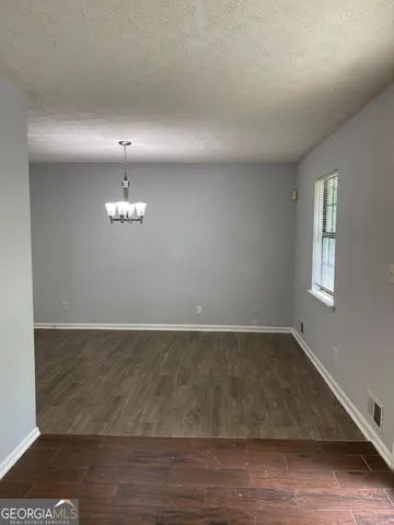 an empty room with wooden floor