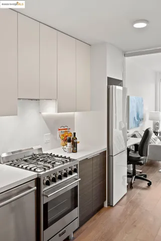 a kitchen with a stove and a refrigerator