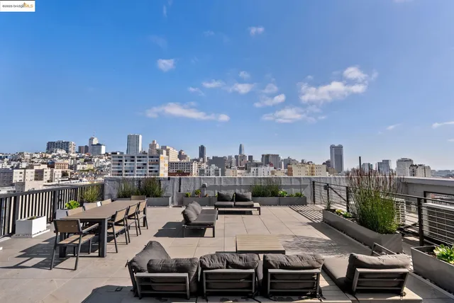 a roof deck view with lawn chairs and potted plants
