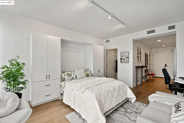 a spacious bedroom with a bed and a couch