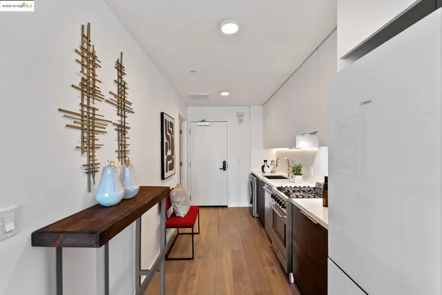 a open kitchen with stainless steel appliances granite countertop a stove and a refrigerator