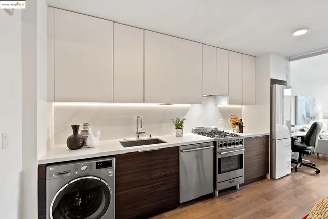 a kitchen with a stove top oven sink and cabinets