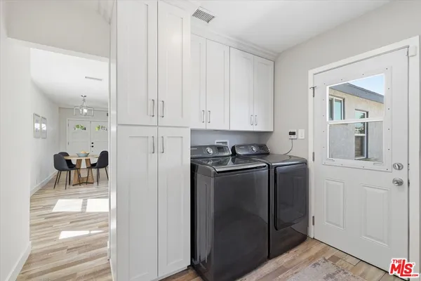 a kitchen with stainless steel appliances granite countertop a refrigerator and a stove