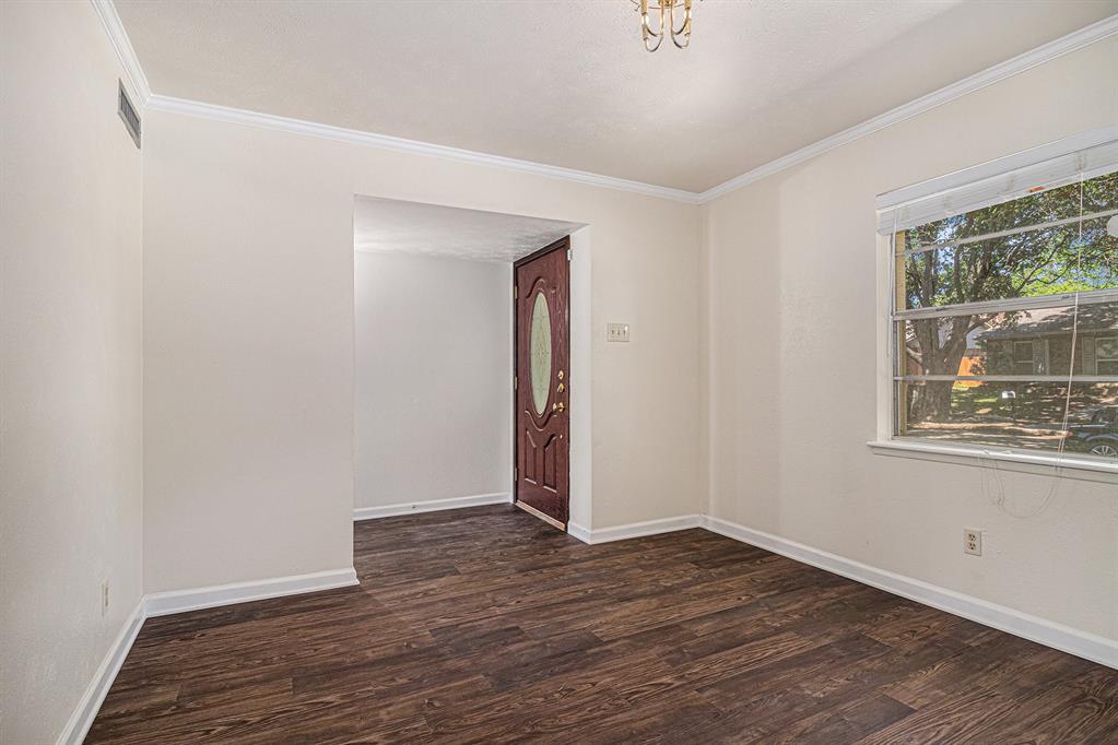 1814 Addington Drive Carrollton, TX 75007 - Photo 4 of 24 Unfurnished room featuring ornamental molding and dark wood-type flooring