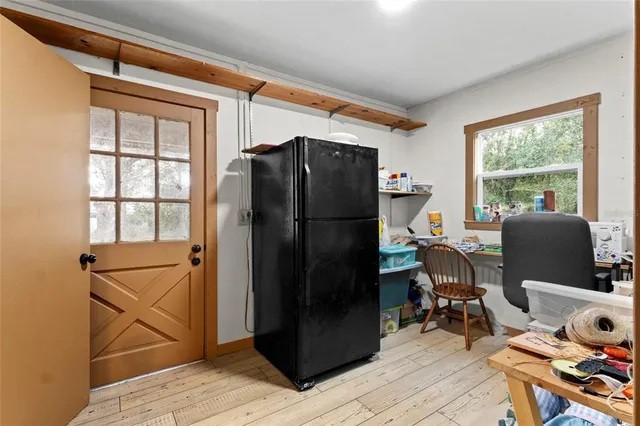 a view of a workspace with furniture and a window