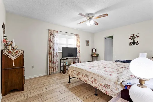 a bedroom with a bed and wooden floor