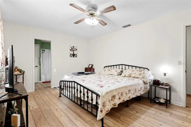 a bedroom with bed and a chandelier