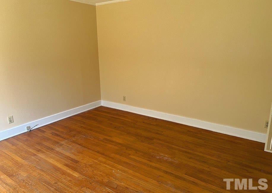 99 Susan Street, Unit 1 & 2 Clinton, NC 28328 - Photo 4 of 9 a view of an empty room with wooden floor and a window