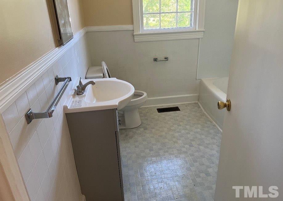 99 Susan Street, Unit 1 & 2 Clinton, NC 28328 - Photo 5 of 9 a bathroom with a sink and toilet