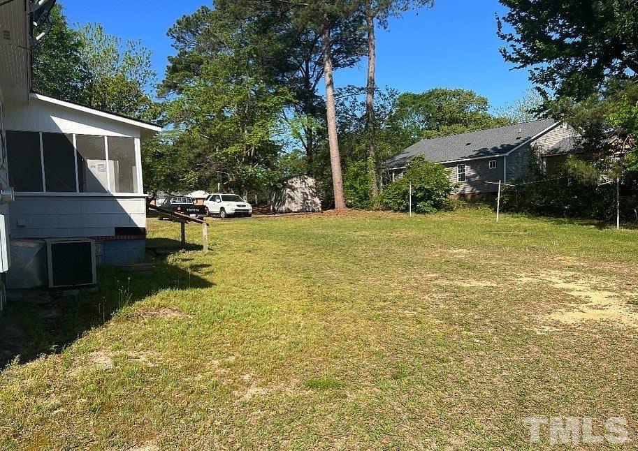 99 Susan Street, Unit 1 & 2 Clinton, NC 28328 - Photo 8 of 9 a view of a patio with table and chairs and potted plants with wooden fence