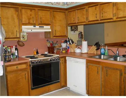 a kitchen with stainless steel appliances granite countertop a stove and a refrigerator